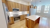 This contemporary 610 square foot apartment in Berwyn, Pennsylvania offers a well-designed living space. The open floor plan seamlessly integrates the kitchen, living, and dining areas, maximizing the use of space. The gourmet kitchen is a standout feature, boasting sleek wood cabinetry, stainless steel appliances, and a convenient island with pendant lighting.

The bedroom, measuring 150 square feet, provides ample space and includes a sizable closet for storage. The bathroom is modern and functional, featuring a wood vanity and a combination tub/shower. Large windows throughout the apartment allow for abundant natural light, creating a bright and airy atmosphere.

The flooring varies, with warm wood-like flooring in the main living areas and plush carpeting in the bedroom. The neutral color palette of the walls provides a versatile backdrop for personal decor. A private balcony or patio, accessible through a glass door, offers additional outdoor living space.

This efficient one-floor layout is perfect for singles or couples seeking a low-maintenance, stylish living environment in a prime location.