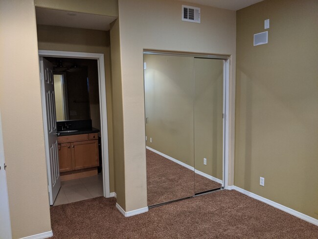 Full Bathroom 1 - attached to Bedroom 1. Closet with closet organizer and mirror. - 109 Cornell Ave