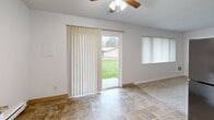 Located at 5200 SW 141st Ave in Beaverton, Oregon, this single-floor, one-bedroom, one-bathroom unit offers a practical and comfortable layout across a modest but well-utilized footprint. The entrance leads into a tiled hallway that connects the main living areas, with ceiling fans featured throughout the unit for year-round comfort.

The living room is bright and open, finished with tile flooring and highlighted by a sliding glass door that opens to an outdoor patio with views of a green lawn. Vertical blinds and an additional window allow for flexible natural light control. The combined kitchen and dining area flows naturally from the living space, featuring white cabinetry, stone-patterned laminate countertops, stainless steel appliances including a dishwasher and range, a double sink, and a baseboard heating unit. Textured ceilings are consistent throughout.

The bedroom offers a comfortable, carpeted retreat with a ceiling fan, a sliding-door closet for storage, a baseboard heater, and a window with outdoor views. A hallway connecting the bedroom to the rest of the unit includes additional closet storage — with four closets total providing generous organization options throughout the home. The bathroom completes the layout, conveniently positioned off the main corridor.