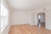 This single-floor unit located at Grantham Road in Norfolk, Virginia, offers a straightforward and functional layout across several well-defined living areas. Warm-toned hardwood flooring runs throughout the main living spaces and rooms, lending a cohesive and inviting character to the interior. White walls provide a clean, neutral backdrop that enhances the brightness of each room.

The living areas are generously proportioned, with windows fitted with blinds that allow natural light to fill the space while maintaining privacy. One room features a multi-bulb pendant light fixture, making it well-suited for use as a dining area. The overall floor plan, as seen in the layout overview, connects the living spaces efficiently to the kitchen and bathroom.

The kitchen is equipped with warm oak cabinetry extending to the upper and lower sections, dark-toned countertops, a stainless single-basin sink, and white electric range. Tile flooring grounds the kitchen area practically. A window above the counter area introduces additional natural light.

The bathroom includes a full-size soaking tub with shower, a wood-vanity with an integrated sink, a toilet, and tile flooring. A window provides ventilation and natural light. The unit presents a clean, move-in ready condition throughout.