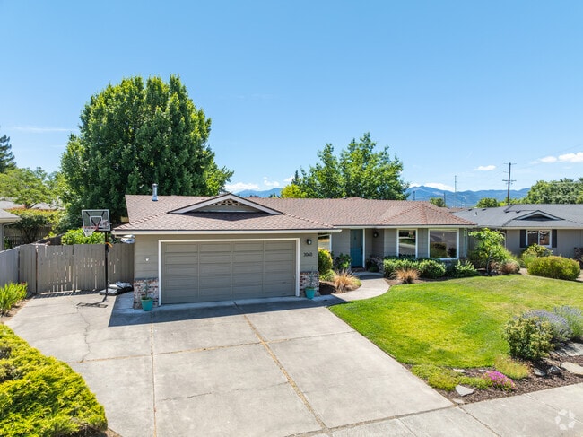 Some homes in Century Village have lush lawns and well manicured plants.