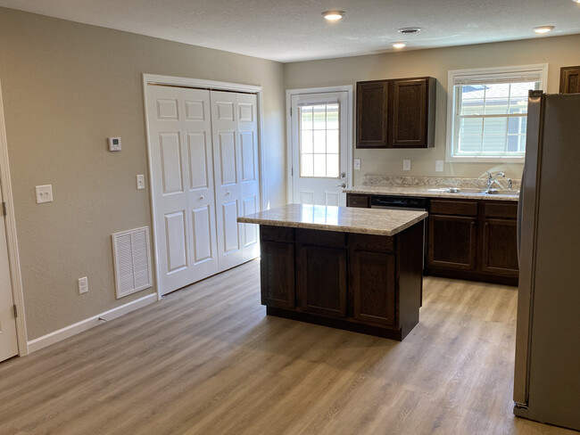 bifold door access to laundry closet off kitchen in units without a garage - Pleasant View Apartments on Carroll Creek