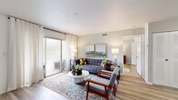 Located on N Course Dr in Pompano Beach, Florida, this single-floor residence offers a thoughtfully designed layout that balances comfort and modern style. The living room serves as the heart of the home, featuring light wood-look flooring, neutral walls, and a large sliding glass door that fills the space with natural light and provides direct access to an outdoor area with views of the surrounding greenery. The open, airy atmosphere is complemented by a media wall and ample room for relaxed seating arrangements.

Adjacent to the living area, the dining space accommodates a full-sized table and flows seamlessly into a well-equipped kitchen. The kitchen features white shaker-style cabinetry, quartz countertops, a stainless steel sink, and a full suite of stainless steel appliances, including a refrigerator, range, built-in microwave, and dishwasher.

The bedroom is generously proportioned, finished with the same wood-look flooring, large windows dressed in sheer curtains, and warm, inviting tones that create a restful retreat. The bathroom is clean and contemporary, offering a vanity with quartz countertops, wood-tone cabinetry, and a combined shower and tub enclosure with sliding glass doors.