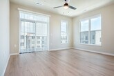 Located at 2692 Botanical Dr in Fitchburg, WI, this well-designed 2-bedroom, 2-bathroom single-floor residence offers a clean, modern aesthetic throughout. Light-toned hardwood-style flooring flows seamlessly across the entire space, creating a bright and cohesive feel. The open kitchen and living area serves as the heart of the home, featuring white shaker cabinetry, a light blue subway tile backsplash, stainless steel appliances including a refrigerator, range, microwave, and dishwasher, and a peninsula that provides additional counter space. Large windows fill the kitchen with natural light and offer views of the surrounding area. Both bedrooms are generously proportioned, each equipped with a ceiling fan and sliding glass door or window access to exterior views. The primary bedroom includes a spacious closet with bifold doors. Three closets total provide ample storage throughout the residence. The two bathrooms are finished with white vanity cabinetry, brushed nickel hardware, and tub-shower combinations. A dedicated laundry area houses a stacked Whirlpool washer and dryer. A private patio and a welcoming entrance complete this thoughtfully laid-out home.