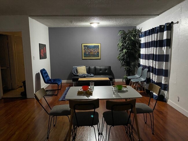 Common area lounge and dinning area with spacious hardwood floors. - 2220 Gale Ave
