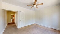 Located at 1769 Noble Rd in East Cleveland, Ohio, this single-floor unit offers three bedrooms, one bathroom, and a kitchen connected by multiple hallways. The layout is efficiently organized, with rooms flowing through a series of connecting hallways that link the living spaces throughout.

The bedrooms are carpeted and finished with crown molding, lending a classic character to each room. The primary bedroom is the most spacious of the three, featuring a ceiling fan, crown molding, and a wide bank of windows that invite generous natural light and outdoor views of the surrounding greenery. One bedroom includes a built-in closet and additional windows, while another offers a ceiling fan and direct access to the hallway.

The kitchen is well-appointed with warm oak cabinetry, ample counter space, a double-basin sink, and a full-size refrigerator. Stone-look tile flooring and a bright window complete the functional cooking space.

The bathroom features a classic clawfoot soaking tub with a shower attachment, tile wainscoting, and a window that provides natural ventilation and light. Baseboard heating is present throughout the unit, ensuring comfort year-round. Crown molding is a consistent architectural detail found across the rooms, adding a touch of traditional style to the overall space.
