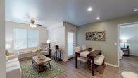 This single-floor residence offers a thoughtfully designed layout that balances comfort and functionality. The open living and dining area is finished with wood-look flooring and neutral-toned walls, creating a warm and inviting atmosphere. Multiple windows with horizontal blinds allow natural light to fill the space, while ceiling fans in the living room and bedrooms provide year-round comfort. A patio door connects the living area to an exterior access point, enhancing the sense of openness.

The kitchen is well-equipped with rich walnut-toned cabinetry, granite countertops, and a full suite of stainless steel appliances, including a refrigerator, range, microwave, and dishwasher. A double-basin sink is positioned beneath a window, adding natural light to the workspace. The L-shaped layout offers ample counter and storage space.

Both bedrooms are generously sized with wood-look flooring, ceiling fans, and large windows. Each room exudes a calm, restful ambiance suited for relaxation. The two bathrooms mirror the kitchen's design aesthetic, featuring granite-topped vanities with rich wood cabinetry, large mirrors with overhead lighting, and shower-tub combinations. The consistent use of granite and matching cabinetry throughout the home ties the overall design together cohesively.