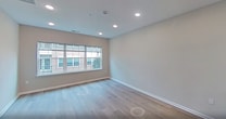 This contemporary 620 square foot apartment offers a harmonious blend of style and functionality. The heart of the home is a modern kitchen, featuring dark wood cabinetry contrasted by white quartz countertops and stainless steel appliances. The L-shaped layout maximizes counter space and includes a built-in microwave and gas range.

Adjacent to the kitchen, the open-concept living area boasts light wood flooring and recessed lighting, creating a bright and airy atmosphere. A large window allows natural light to flood the space, offering views of the surrounding area. The 130 square foot primary bedroom continues the modern aesthetic with neutral walls and ample floor space for personalization.

The bathroom showcases a sleek design with a floating vanity, large mirror, and contemporary lighting. Gray tile flooring complements the overall color scheme. Throughout the apartment, white doors and trim add a crisp, clean look.

A small hallway connects the living spaces, providing easy flow and featuring a closet for additional storage. The apartment's efficient layout makes excellent use of its 620 square feet, offering a comfortable living space in a single-floor plan. With its upscale finishes and thoughtful design, this apartment in The Lofts at Gloucester presents an ideal urban living solution.