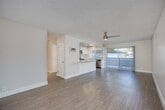 Located at 612 Los Arbolitos Blvd in Oceanside, California, this well-appointed 2-bedroom, 3-bathroom residence offers a clean, modern aesthetic throughout its thoughtfully designed single-level floor plan. Light wood-style flooring flows seamlessly across the living areas, complemented by neutral walls and textured ceilings that lend a classic coastal character.

The open-concept living and dining area is bright and airy, benefiting from natural light streaming through a sliding glass door that leads to a private balcony. A ceiling fan adds comfort to the spacious living area. The kitchen is a standout feature, boasting white shaker cabinetry reaching to the ceiling, a white quartz peninsula countertop, recessed lighting, and a full suite of stainless steel appliances including a refrigerator, range, microwave, and dishwasher — all centered around a window with natural light.

Both bedrooms are generously proportioned, with the primary bedroom featuring mirrored sliding closet doors that enhance the sense of space and light. In total, four closets provide ample storage throughout. The three bathrooms are finished with white vanities, quartz countertops, and tub-shower combinations. A connecting hallway links the private bedroom wing to the main living areas, creating a functional and comfortable layout ideal for everyday living.