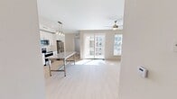 This contemporary 780 square foot apartment offers a blend of comfort and style. The space comprises two bedrooms, including a primary bedroom of 140 square feet, and two well-appointed bathrooms. The open-concept living area is illuminated by natural light from large windows and sliding glass doors leading to a private balcony. This outdoor space provides stunning views of the complex's centerpiece: a large, L-shaped swimming pool.

The kitchen is a highlight, featuring modern white cabinetry, stainless steel appliances, and granite countertops. A central island with pendant lighting serves as both a prep area and casual dining space. Throughout the apartment, you'll find ceiling fans, carpeted bedrooms, and light wood-look flooring in the main living areas.

Both bathrooms are designed with functionality and style in mind, offering granite vanities, large mirrors, and a combination of tub/shower and walk-in shower options. The apartment's neutral color palette and clean lines create a canvas for personal style while maintaining a fresh, modern aesthetic. Located at 900 N Tryon, this unit is part of a larger residential complex that likely offers additional amenities to its residents.