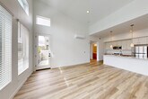 Located at 2611 First St in Napa, CA, this thoughtfully designed one-bedroom, one-bathroom residence offers a bright, modern living experience across a single floor. The open-concept living, dining, and kitchen area is the heart of the home, boasting dramatically high ceilings with clerestory windows that flood the space with natural light. Light-toned hardwood flooring runs throughout, enhancing the airy, contemporary feel. A wall-mounted mini-split system provides efficient climate control.

The kitchen features a central island with a sleek quartz countertop, an undermount sink, pendant lighting, white upper cabinetry, warm wood lower cabinetry, and stainless steel appliances including a refrigerator, range, and microwave. A sliding door in the living area opens to a private balcony with hillside views of the Napa landscape.

The bedroom is finished with plush carpeting and includes a sliding glass door to its own balcony, offering peaceful outdoor access and scenic views. A dedicated closet provides ample storage. The bathroom is clean and functional, featuring wood-toned cabinetry, a quartz vanity, and a tub/shower combination. In-unit laundry completes this well-appointed residence.