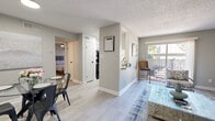 Located in Houston's El Camino Village community, this one-bedroom, one-bathroom unit offers a thoughtfully designed single-floor layout with modern updates throughout. Light gray walls, light-toned laminate flooring, and textured ceilings create a clean, cohesive aesthetic across the main living areas.

The open-concept living and dining area is bright and inviting, with a sliding glass door that floods the space with natural light and provides direct access to a private outdoor balcony. The kitchen features granite countertops, white shaker-style cabinetry with matte black hardware, a classic subway tile backsplash, and black appliances, with a window that brings in additional natural light.

The bedroom is a comfortable retreat with plush carpet flooring, a ceiling fan, a natural light window, a dedicated closet, and convenient access to the full bathroom. The bathroom is finished with a granite-topped vanity, white cabinetry, a framed mirror, and a tiled shower-tub combination.

A utility closet with washer and dryer hookups adds everyday practicality. The hallway connects all rooms efficiently, completing this well-organized and move-in-ready layout suited for comfortable single-occupant living in the Houston area.