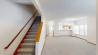 Located at 2680 Silver Oak Dr in Columbus, Ohio, this two-story home offers a thoughtfully arranged layout across two floors. The main level welcomes you through a dedicated entrance that opens into a spacious living room, highlighted by a tile-surround fireplace and light wood-style flooring that extends throughout. Natural light filters in through window blinds, creating a bright and inviting atmosphere. The adjacent kitchen features warm oak cabinetry, a breakfast bar pass-through, white appliances including a refrigerator, electric range, and built-in microwave, along with a window overlooking the exterior. A carpeted staircase with a wooden handrail leads to the upper level. The second floor hosts two bedrooms, each with plush carpet flooring, natural light, and access to closet space. The primary bedroom is generously sized and includes its own dedicated closet. Three full bathrooms are distributed across both floors, each finished with oak vanities, white countertops, and brushed nickel hardware; one features a tub-shower combo. A dedicated laundry room with washer and dryer hookups, a wire shelving rod, and vinyl flooring adds practical convenience. Textured ceilings are present throughout the home.