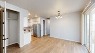This single-story, 2-bedroom, 2-bathroom home offers a clean, modern aesthetic throughout its thoughtfully designed layout. Light wood-look flooring flows seamlessly through the main living areas, complementing the neutral gray walls and white trim that create a bright, cohesive atmosphere.

The kitchen is a standout feature, showcasing white shaker-style cabinetry with modern hardware, light quartz countertops, and a full suite of stainless steel appliances including a refrigerator, dishwasher, range, and microwave. A peninsula provides additional prep space and opens to the dining and living areas, enhanced by a classic chandelier overhead. Sliding glass doors in the living area invite natural light and provide access to the outdoor space.

Both bedrooms are generously sized, each featuring ceiling fans with light fixtures and windows with blinds. The primary bedroom includes a well-sized closet with built-in shelving and carpet flooring. The second bedroom mirrors this comfortable layout. A laundry area is conveniently located within the home.

The bathrooms are finished with wood-look flooring, white vanities, and modern fixtures. One bathroom features a walk-in glass-enclosed shower with dark bronze hardware and a natural light window above.

The attached garage offers ample space with a panel-style door and an automatic opener, completing this functional and move-in-ready home.