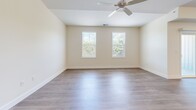 Located at 1115 York Rd in Gettysburg, PA, this thoughtfully designed single-story home offers three bedrooms, two bathrooms, and a well-organized layout ideal for comfortable everyday living. Warm wood-look flooring flows consistently throughout the entire home, complementing the bright, neutral palette that gives every room a clean and contemporary feel.

The open-concept kitchen and living area serves as the heart of the home. The kitchen is outfitted with white shaker-style cabinetry, dark countertops, a full suite of stainless steel appliances, and a spacious breakfast bar with pendant lighting overhead—perfect for casual dining or entertaining. Recessed lighting adds to the modern aesthetic of this shared space.

Each of the three bedrooms features large windows that invite generous natural light and offer pleasant views of surrounding greenery. The generously sized primary bedroom includes a ceiling fan and walk-in closet with built-in wire shelving. The two bathrooms mirror the home's clean design language, featuring white cabinetry, dark countertops, and wood-look flooring. The primary bathroom includes a dual-sink vanity and a walk-in shower with white tile surround and sleek chrome fixtures, while the secondary bathroom offers a single vanity with a window for natural light. A hallway connects all rooms, contributing to the home's efficient and functional flow.