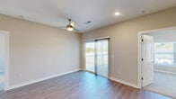 Located at 7011 Star Oaks Ln in Charlotte, NC, this well-appointed 2-bedroom, 2-bathroom home offers a thoughtfully designed single-level layout. The open-concept kitchen is a standout feature, showcasing white shaker cabinetry, granite countertops, a subway tile backsplash, and a full suite of stainless steel appliances including a refrigerator, range, and microwave. A center island with a sink and pendant lighting connects seamlessly to the living room, creating an inviting space for everyday living and entertaining. The living area features hardwood-style flooring and a ceiling fan, with sliding glass doors opening onto a private balcony. The primary bedroom continues the hardwood-style flooring and includes its own en-suite bathroom with a walk-in shower and granite vanity, as well as a walk-in closet with wire shelving. The second bedroom is carpeted, features a ceiling fan, large windows for natural light, and a double-door closet. The second bathroom offers a full soaking tub and shower combination. Additional storage is provided by multiple closets and a pantry, rounding out a functional and comfortable floor plan.