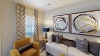 This thoughtfully designed single-story residence offers a cohesive blend of modern style and everyday functionality throughout its well-proportioned layout. The entryway welcomes visitors with warm neutral tones, crown molding, and rich hardwood-style flooring that flows through the main living areas.

The living room is a bright, inviting space accented by crown molding and large windows dressed with patterned curtains that allow natural light to fill the room. Adjacent to the living area, the dedicated dining room features hardwood-style floors, crown molding, and a pendant chandelier, creating an elegant setting for gatherings.

The kitchen is well-equipped with dark espresso cabinetry, granite countertops, stainless steel appliances including a range, microwave, and refrigerator, complemented by track lighting and hardwood-style flooring.

The bedrooms are carpeted and serene, each offering generous closet space, including walk-in closets with built-in shelving. Windows with blinds and draping curtains provide both privacy and natural light.

The bathrooms are finished with granite-topped vanities, dark cabinetry, and tile flooring. One bathroom features a tub-shower combination with subway tile surround, while another includes a dedicated linen closet and additional open shelving for storage.
