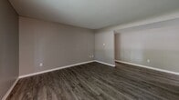 Located at 229 Parkwood Drive in Lansing, Michigan, this one-bedroom, one-bathroom unit offers a well-organized single-floor layout with modern updates throughout. The living room is a bright, open space featuring durable wood-style flooring, neutral taupe walls, and large windows fitted with vertical blinds that invite generous natural light and offer views of the surrounding greenery outside.

The kitchen is thoughtfully appointed with crisp white shaker-style cabinetry, light speckled countertops, a double-basin sink, and stainless steel appliances including a refrigerator and electric range, all set over light wood-style flooring that complements the clean, contemporary aesthetic.

The bedroom is a comfortable, well-proportioned room with the same wood-style flooring, neutral walls, and a large window that continues the natural light theme. A set of double bi-fold closet doors provides ample storage space, adding practical functionality to the room.

The bathroom features a full tub and shower combination with floor-to-ceiling rectangular tile surrounds in a soft gray tone, complemented by brushed nickel fixtures and wood-style flooring, creating a cohesive and modern feel. The vanity includes a countertop with an undermount sink and a mirrored cabinet above. Throughout the unit, consistent finishes and a neutral color palette create a clean, move-in-ready environment.