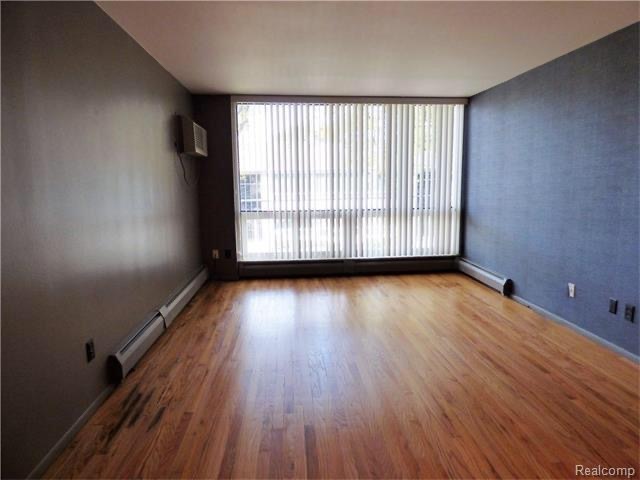 Living room with wall size windows - 125 E 14 Mile Rd