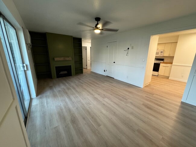 Front room with decorative fireplace, built-in bookshelves and a TV mount (not pictured) - 387 N 200 E