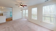 Located at 249 Marcliffe Dr in Valparaiso, Indiana, this single-floor home offers a thoughtfully designed layout filled with natural light throughout. The generous living area features soft carpeting, a ceiling fan with light fixture, and a charming bay-style window arrangement that frames views of the surrounding greenery, creating a warm and inviting atmosphere.

The kitchen is equipped with white cabinetry, a gas range, over-the-range microwave, and a full-size refrigerator, all complemented by hardwood flooring and ample counter space for meal preparation. Each bedroom is carpeted and outfitted with a ceiling fan, providing comfortable, well-lit retreats. One bedroom includes direct access to an outdoor patio or deck, while another features a large window overlooking the exterior. A spacious walk-in closet with built-in wire shelving offers generous storage.

The bathrooms feature tile flooring in warm earth tones, white vanities, and full tub-shower combinations, with one bathroom also including a separate soaking tub. Throughout the home, neutral tones and clean finishes create a bright, move-in-ready environment. The overall layout, visible in the overhead dollhouse view, reflects an efficient and functional single-story floor plan well-suited for comfortable everyday living.