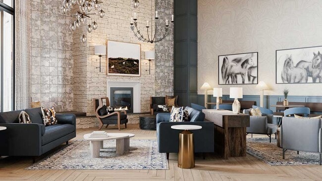 Elegant resident lounge featuring a stone fireplace, layered lighting, plush seating, and curated artwork in a warm, upscale setting - Mesquite Trails at Brooks
