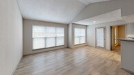 This single-story residence at 3611 Wheeler Rd in Augusta, Georgia offers a well-appointed layout with a thoughtful mix of finishes throughout. The living area immediately impresses with its vaulted ceilings, which lend a sense of openness and volume to the space. Large windows fitted with horizontal blinds allow generous natural light to fill the room, complemented by light wood-look flooring that extends throughout the main living areas.

The kitchen features dark cabinetry paired with granite-style countertops and a peninsula that creates a natural division between the kitchen and living area. Black appliances, including a gas range, microwave, and refrigerator, are installed alongside a white tile backsplash, providing a functional and contemporary workspace.

The bedrooms are carpeted for comfort and each includes a ceiling fan with light fixture. Windows provide natural light, and closet space is available, with at least one bedroom featuring a walk-in closet. The neutral wall tones carry throughout, maintaining a cohesive aesthetic.

The bathrooms are finished with wood-look tile flooring, granite-topped vanities with dark cabinetry, and tiled soaking tubs. One bathroom features a separate elongated layout with additional storage access. Textured walls and brushed nickel hardware complete the refined yet practical interior throughout this single-floor home.