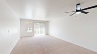 Located at 5601 Natomas Blvd in Sacramento, CA, this single-story, 2-bedroom, 2-bathroom home offers a well-organized and functional layout across a comfortable footprint. The open-concept living room is bright and airy, featuring plush carpeting, a ceiling fan, and large sliding glass doors flanked by a window that invite abundant natural light and outdoor views. An adjacent window nook with a distinctive arched transom window adds a charming architectural detail to the dining or entry area, finished with wood-look flooring that extends through the kitchen and hallways. The kitchen features light wood cabinetry with granite-style countertops, a built-in dishwasher, and a pass-through opening to the living area. The spacious primary bedroom is carpeted and equipped with a ceiling fan and ample natural light. The second bedroom also offers carpet, a ceiling fan, a closet, and a bright window. Both bathrooms are finished with wood-look flooring, light wood vanities with stone-style countertops, and walk-in showers. Additional highlights include a dedicated laundry area, multiple hallways with closet storage, and an attached garage with an automatic opener, providing convenient and secure parking.