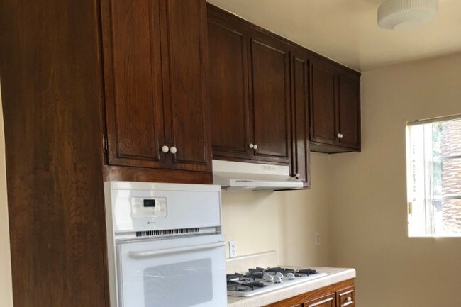 Dark wood cabinets w/stove, oven, dish washer - 10801 La Grange Ave