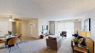 Located at 38360 Tamarac Blvd in Willoughby, Ohio, this single-floor residence offers three bedrooms and two bathrooms across a well-organized layout. The living room is bright and welcoming, anchored by large sliding glass doors with vertical blinds that flood the space with natural light and provide outdoor views. Soft carpeting runs throughout the living and bedroom areas, adding warmth and comfort underfoot. The combined dining area sits adjacent to the living room and features a ceiling fan, closet storage, and ample room for a full dining set. The kitchen is equipped with light wood cabinetry, a double sink, dishwasher, and a window that brings in additional natural light, along with space for casual dining. The generously sized primary bedroom accommodates a full bedroom suite and includes a window with outdoor views, a closet, and direct access to one of the bathrooms. Both bathrooms feature light-toned vanities with large mirrors and tile flooring. A second full bathroom with a vanity and mirror serves the remaining bedrooms. The entryway provides a clean transition into the home with carpeted flooring and a secure front door. Neutral wall tones and textured ceilings are consistent throughout, creating a cohesive and functional living environment.