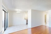 Located on Westwood Boulevard in the heart of Los Angeles, this 2-bedroom, 2-bathroom residence offers a well-organized single-floor layout that maximizes its comfortable footprint. Rich hardwood flooring flows throughout the main living areas, complemented by crisp white walls and textured ceilings that lend a clean, bright aesthetic throughout.

The open living and dining area serves as the heart of the home, featuring a classic fireplace with a granite surround and sliding glass doors that open onto a private balcony, filling the space with natural light and outdoor views. A chandelier adds a refined touch to the dining area.

The galley-style kitchen is efficiently designed with white cabinetry, granite countertops, a mosaic tile backsplash, stainless steel appliances including a gas range and dishwasher, and tile flooring — offering both style and functionality.

Both bedrooms are generously proportioned with warm hardwood floors, large windows that invite natural light, and wall-unit climate control. The primary bedroom includes mirrored sliding closet doors, enhancing the sense of space.

The two bathrooms are neatly appointed with tile flooring and granite-topped vanities. One features a shower/tub combo, while the other provides a compact, functional layout. Together, these spaces create a comfortable and practical home in a prime Los Angeles location.