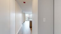 Located at 400 E South Water Street in the heart of Chicago, this high-rise unit offers a modern living experience defined by expansive floor-to-ceiling windows that frame sweeping views of the iconic Chicago skyline. Light-toned hardwood flooring flows throughout the main living areas, lending a clean and contemporary aesthetic.

The updated kitchen is well-appointed with gray shaker-style cabinetry, a crisp white quartz countertop, a subway tile backsplash, and a full suite of stainless steel appliances including a gas range, built-in microwave, dishwasher, and refrigerator. A central island provides additional prep and dining space.

The living area is bright and open, benefiting from the generous wall-to-wall glazing that floods the space with natural light while offering commanding city views. The bedroom features plush carpeting, a large built-in closet, and its own set of floor-to-ceiling windows continuing the skyline panorama.

The bathroom is finished with a gray vanity topped with white quartz, a mirrored medicine cabinet, and a tiled soaking tub with an overhead shower. Clean white walls and neutral tones throughout create a cohesive, move-in ready environment ideal for those seeking a well-positioned urban residence in Chicago's vibrant Streeterville neighborhood.