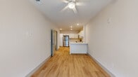 Located at 8000 Arlington Expressway in Jacksonville, FL, this one-bedroom, one-bathroom unit offers a clean, modern layout designed for comfortable everyday living. Light-toned luxury vinyl plank flooring runs throughout the entire space, creating a cohesive and easy-to-maintain interior.

The open-concept main area seamlessly connects the living room, dining area, and kitchen. The kitchen is well-equipped with white shaker-style cabinetry, light countertops, a peninsula island, and a full suite of stainless steel appliances including a refrigerator, range, microwave, and dishwasher. A ceiling fan overhead enhances airflow in the combined living and dining area.

The bedroom is a comfortable, well-proportioned room featuring a ceiling fan, large windows with exterior views that bring in abundant natural light, and access to a dedicated closet. The bathroom is thoughtfully laid out with a white vanity, ample counter space, and a glass-enclosed walk-in shower. A hallway connects the private areas of the unit with efficient use of space throughout.

Neutral wall tones, recessed lighting, and consistent flooring give the unit a bright, cohesive aesthetic from room to room, making it a functional and inviting home.