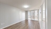 Located at 140 Main St W in the heart of Hamilton, Ontario, this well-designed one-bedroom, one-bathroom unit offers a thoughtfully efficient layout with modern finishes throughout. Warm wood-look laminate flooring flows seamlessly across every room, complementing the crisp white walls and clean contemporary aesthetic.

The living room is a bright, open space anchored by large sliding glass doors that lead to a private balcony, offering views of Hamilton's urban skyline. The balcony provides an ideal outdoor retreat with an elevated city perspective.

The kitchen features flat-front white cabinetry extending to the ceiling for generous storage, paired with stainless steel appliances including a refrigerator, electric range, and built-in microwave. Light countertops and matching flooring give the kitchen a cohesive, modern feel.

The bedroom is a comfortable, well-proportioned room filled with natural light from a large window. It includes a sliding-door closet, providing practical built-in storage. The four-piece bathroom is finished with crisp white subway tile surrounding a soaker tub and shower combination, complemented by clean white fixtures throughout.

A welcoming hallway entry connects all areas of the unit, giving the layout a logical and functional flow. The overall ambiance is bright, clean, and move-in ready.