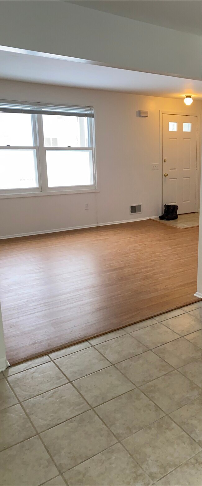 Main living room - new flooring in living room meets kitchen tile - 4308 Lake Ave