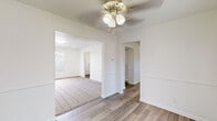 This two-floor residence at 7801–7813 Raintree Dr in Louisville, Kentucky, presents a clean, neutral aesthetic throughout its well-maintained interior. The main living area features wood-look plank flooring and flows openly into adjacent spaces, with ceiling fans providing comfort across multiple rooms. A sliding glass door in one room connects directly to an outdoor patio area, filling the space with natural light and offering views of the surrounding greenery.

The kitchen is outfitted with grey cabinetry, light stone-look countertops, a mosaic tile backsplash, and black appliances including a range, dishwasher, and refrigerator. Recessed lighting and a window above the sink keep the kitchen bright and functional.

Bedrooms are carpeted and equipped with ceiling fans and natural light from windows fitted with blinds. Several bedrooms include built-in closets with bifold doors, offering practical storage solutions. One upper-level room features recessed lighting and a large window that draws in generous sunlight.

Bathrooms feature wood-look tile flooring, light cabinetry with vanities, and clean white fixtures. One bathroom includes a full tub-shower combination. The overall design is straightforward and well-maintained, making for a comfortable and practical living space.