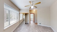 Located at 737 SW 17th Ave in Portland, Oregon, this one-bedroom, one-bathroom unit offers a practical and well-organized single-floor layout. Light wood-style flooring flows throughout the space, creating a clean, cohesive look that ties each room together.

The kitchen is arranged in an efficient L-shape, featuring white cabinetry with warm wood trim accents, light countertops, and a full suite of appliances including an electric range, built-in microwave, refrigerator, and a single-basin sink. Overhead fluorescent lighting keeps the space well-illuminated.

The living area is open and simply designed, with neutral beige walls and windows that invite natural light and offer views of surrounding greenery. A warm-toned wood entry door provides a welcoming focal point near the kitchen.

The bedroom is comfortably sized, offering two windows for ample natural light and pleasant outdoor views. A ceiling fan provides year-round comfort, while mirrored sliding closet doors add a sense of depth and additional storage. A second closet is also available within the unit.

The bathroom is clean and functional, featuring a full soaking tub with shower, a single vanity with a large mirror, and light wood-style flooring that matches the rest of the unit. The overall ambiance is bright, neutral, and move-in ready.