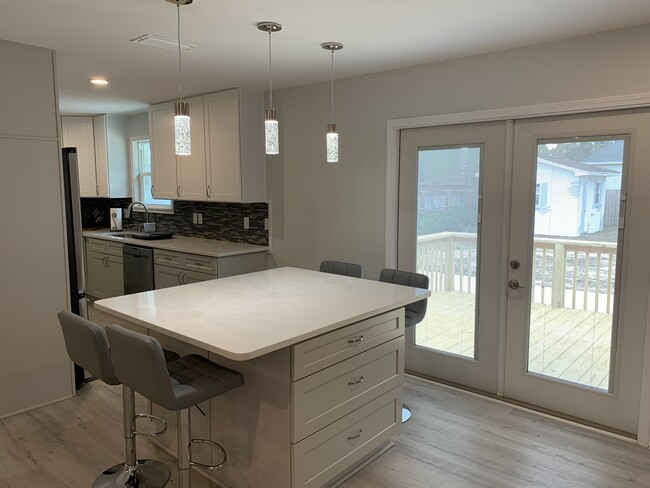 Dining area with access to patio deck. - 1301 E Leonard St