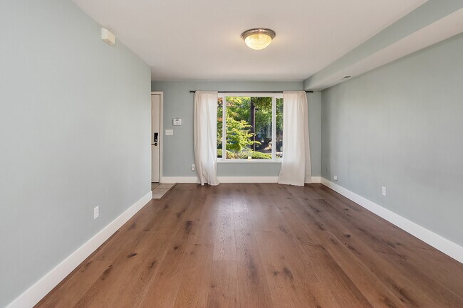 Open floor plan on main floor with brand new flooring. - 7051 8th Ave NW
