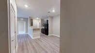 Located at 2712 Country Club Dr in Tallahassee, FL, this well-appointed 2-bedroom, 2-bathroom residence offers a thoughtfully designed single-level layout. The open-concept living and kitchen area serves as the heart of the home, featuring light wood-style luxury vinyl plank flooring, recessed lighting, and neutral warm-toned walls that create a clean, welcoming atmosphere. The kitchen is equipped with dark espresso cabinetry, white countertops, a double-basin sink, black appliances including a refrigerator and range, and a peninsula that provides additional prep space and a natural divide between the kitchen and living area. The living room offers access to a private balcony through glass-paned doors, with a ceiling fan overhead adding comfort. Both bedrooms are carpeted and generously sized, each featuring ceiling fans and multiple windows that invite natural light. The primary bedroom connects to its own bathroom with a tub-shower combination. Closet space is well-served by two dedicated closets, including a walk-in closet outfitted with wire shelving systems for organized storage. The second bathroom also features a tub-shower combo. Together, the neutral finishes, practical layout, and modern touches make this a comfortable and functional Tallahassee residence.