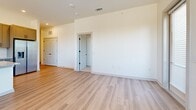 Located at 3108 McGinnis Ferry Rd in Suwanee, GA, this well-appointed single-floor home offers a thoughtfully designed layout with 3 bedrooms, 2 bathrooms, and 4 closets. The open-concept living, dining, and kitchen area serves as the heart of the home, highlighted by light hardwood-style flooring, recessed lighting, and an abundance of natural light. The kitchen is a standout feature, showcasing granite countertops, a center island with a built-in sink, gray shaker-style cabinetry reaching to the ceiling, a white subway tile backsplash, stainless steel appliances, and pendant lighting overhead. The spacious primary bedroom features large windows with outdoor views, a ceiling fan, and direct access to a generous closet with built-in shelving and hanging rods. The additional bedrooms are carpeted and bright, each with windows that let in ample natural light. The bathrooms are finished with granite vanities, gray cabinetry, and elegant tiled tub-shower surrounds with matte black fixtures. A dedicated laundry room and entrance area add everyday convenience, while the clean, neutral color palette throughout creates a fresh and modern ambiance.