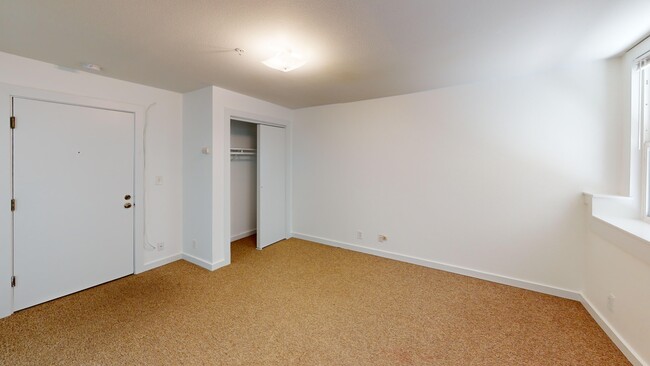 Bright bedroom with wood-like floor and a closet - 2333 Channing Way