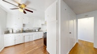 Located at 10800 Wright Road in South Gate, CA, this single-story, one-bedroom, one-bathroom unit offers a well-organized layout with a practical flow between rooms. The living room is bright and open, featuring warm hardwood-style flooring, a textured ceiling, a ceiling fan with light fixture, and a wall-unit air conditioner. Large windows dressed with vertical blinds allow natural light to fill the space throughout the day.

The combined kitchen and dining area is functionally designed, showcasing white cabinetry, granite-style countertops, a double-basin stainless steel sink, and a gas range. The hardwood-style flooring continues here, and a ceiling fan provides added comfort. Ample cabinet storage is available both above and below the counters.

The bedroom is a comfortable, carpeted retreat with its own ceiling fan, a large window with vertical blinds for natural light and privacy, and access to closet storage. Three closets are distributed throughout the unit, offering generous storage capacity.

The bathroom is clean and functional, featuring a full tub and shower combo enclosed by sliding glass doors, a toilet, and a window that provides natural ventilation. The hallway connects all areas efficiently, completing the unit's thoughtful and compact layout.