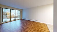 This well-designed 51 square meter apartment in Coquitlam offers a perfect blend of comfort and functionality. The single-floor layout comprises one bedroom, one bathroom, and an open-concept kitchen and living area. The primary bedroom, measuring 14 square meters, provides a cozy retreat with a window allowing natural light to filter in.

The living space is characterized by its warm hardwood flooring, which extends throughout the apartment, creating a seamless and inviting atmosphere. Large sliding glass doors in the living room lead to a private balcony, offering outdoor space and views of the surrounding area.

The kitchen features clean, white cabinetry contrasted by dark countertops, creating a modern aesthetic. It's equipped with essential appliances, including a dishwasher, making it both functional and stylish.

The bathroom continues the modern theme with a white color palette, featuring a combination of tiled and smooth surfaces. It includes a bathtub with a shower, a toilet, and a vanity with ample storage space.

Throughout the apartment, neutral-toned walls and ample windows create a bright, airy feel, maximizing the sense of space in this compact yet efficient layout. The property also includes a closet for additional storage, ensuring all living essentials are accommodated within this well-planned urban dwelling.