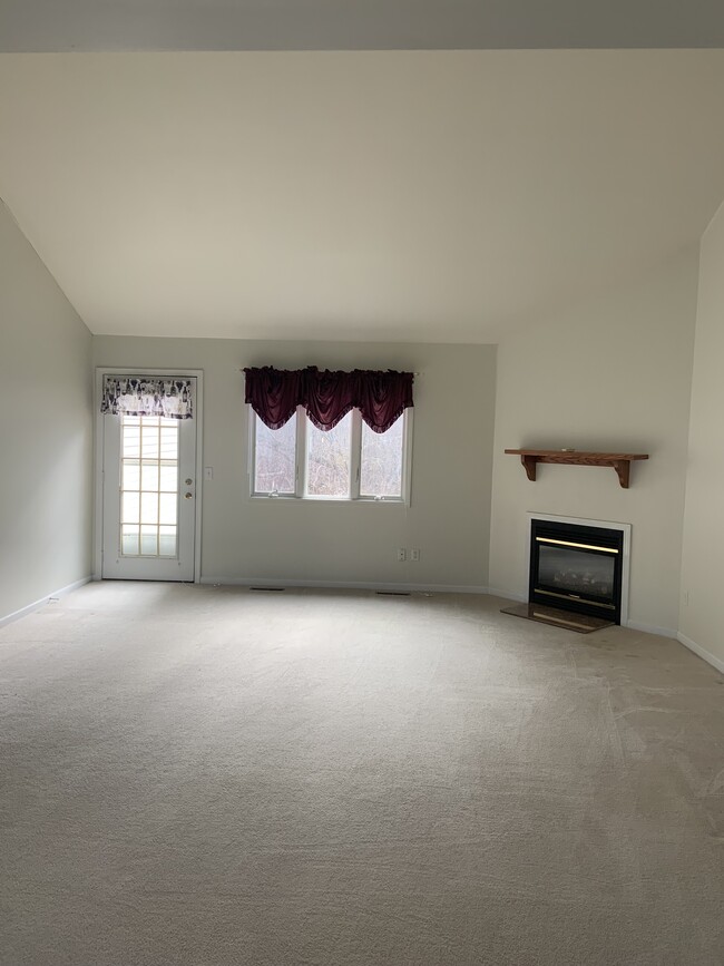 Living room w/ fireplace and back patio access - 6909 Campbell Blvd