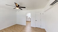 Located at 1815 Clement Ave in North Charleston, South Carolina, this efficiently designed single-floor unit makes smart use of its space across a living room, kitchen, and bathroom. The living room is bright and welcoming, featuring light-toned hardwood-style flooring, crisp white walls, and a ceiling fan with a built-in light fixture. A wall-mounted mini-split unit provides climate control, while a window with blinds allows natural light to fill the room. The kitchen is thoughtfully appointed with white shaker-style cabinetry, granite countertops, a classic subway tile backsplash, and a double-basin sink beneath a window. Stainless steel appliances — including a refrigerator, electric range, over-the-range microwave, and dishwasher — complete the modern setup. The bathroom offers a clean, polished aesthetic with a tub-shower combination tiled in large-format marble-look porcelain with silver-toned fixtures. Consistent light hardwood-style flooring runs throughout the main areas, tying the space together with a cohesive, contemporary feel. The overall design is clean, functional, and move-in ready, making it a practical option in the North Charleston area.
