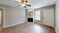 Located at 315 Amesbury Dr in Lafayette, Louisiana, this single-story, 2-bedroom, 2-bathroom home offers a practical and comfortable layout designed for easy living. Warm-toned wood-look flooring runs throughout the main living areas, complementing the neutral beige walls and white trim found across every room.

The living room serves as the heart of the home, highlighted by a corner fireplace with a tile surround and a large mirror above the mantle, a ceiling fan with light fixture, and a window that invites natural light. The combined kitchen and dining area features warm oak cabinetry, laminate countertops, a full suite of white appliances including a refrigerator, electric range, and built-in microwave, as well as a pantry for additional storage.

The generously sized primary bedroom includes a ceiling fan, closet access, and ample floor space. The second bedroom is equally well-appointed with its own ceiling fan. Both bathrooms offer oak vanity cabinetry, a tub-shower combination, and overhead lighting. A dedicated laundry area and additional closets throughout add to the home's functionality. A connecting hallway ties the layout together, providing a smooth and logical flow between all rooms.