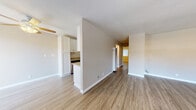 Located at 1390 Creekside Dr in Walnut Creek, CA, this single-floor residence offers a clean, modern aesthetic with thoughtfully updated finishes throughout. The open living area is finished with light hardwood-style flooring and neutral-toned walls, creating a bright and welcoming atmosphere. Ceiling fans are installed in the living and bedroom areas, providing both comfort and a functional design touch. A wall-unit air conditioner in the living space ensures year-round climate control. The kitchen is appointed with white shaker-style cabinetry, granite-look countertops, and stainless steel appliances, including a refrigerator, electric range, and dishwasher. A galley-style layout maximizes efficiency while maintaining a polished look. The bedroom features a ceiling fan with light fixture, hardwood-style flooring, and a window with views of surrounding greenery, filling the room with natural light. A sliding glass door in a secondary space opens to an outdoor area, framed by vertical blinds. The bathroom is well-appointed with a white vanity, granite-look countertop, undermount sink, brushed nickel fixtures, and a tiled shower-tub combination. Consistent flooring and finishes throughout the space contribute to a cohesive and contemporary feel.