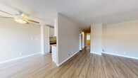 Located at 1390 Creekside Dr in Walnut Creek, CA, this single-floor residence offers a clean, modern aesthetic with thoughtfully updated finishes throughout. The open living area is finished with light hardwood-style flooring and neutral-toned walls, creating a bright and welcoming atmosphere. Ceiling fans are installed in the living and bedroom areas, providing both comfort and a functional design touch. A wall-unit air conditioner in the living space ensures year-round climate control. The kitchen is appointed with white shaker-style cabinetry, granite-look countertops, and stainless steel appliances, including a refrigerator, electric range, and dishwasher. A galley-style layout maximizes efficiency while maintaining a polished look. The bedroom features a ceiling fan with light fixture, hardwood-style flooring, and a window with views of surrounding greenery, filling the room with natural light. A sliding glass door in a secondary space opens to an outdoor area, framed by vertical blinds. The bathroom is well-appointed with a white vanity, granite-look countertop, undermount sink, brushed nickel fixtures, and a tiled shower-tub combination. Consistent flooring and finishes throughout the space contribute to a cohesive and contemporary feel.