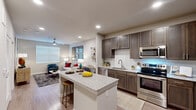 Located at 22103 Gosling Road in Spring, TX, this single-story, 1-bedroom, 2-bathroom residence offers a thoughtfully designed layout that maximizes functionality and comfort. The open-concept kitchen and living area serves as the heart of the home, where rich dark-brown cabinetry, a classic white subway tile backsplash, granite countertops, and a full suite of stainless steel appliances—including a dishwasher, microwave, electric range, and French door refrigerator—create an impressive culinary space. A central island with seating provides additional prep space and casual dining. Wood-style plank flooring flows seamlessly throughout, adding warmth and continuity. The living room is bright and welcoming, featuring large windows with natural light, a ceiling fan, and ample space for comfortable furnishings. The bedroom is a calm retreat, offering natural light through a broad window and a ceiling fan overhead, while the dedicated closet provides organized storage. Two full bathrooms include a tub-shower combination with white subway tile surround and vanities with granite countertops. A dedicated in-unit laundry area with wire shelving completes the home, adding everyday convenience to this well-finished residence.